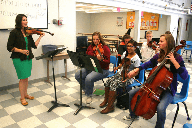 Music instructor Emily Athman has 34 students in the high school orchestra class – so large they are too big for her classroom and the students set up in the lunch room, between meals. “We make the most of our time available,” said Athman. “The students set up the rehearsal space and then reset for lunch.”